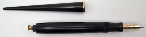 Comes with Parker Duofold Jr desk fountain pen in black with gold filled trim. Nib is Fine. Button filler.